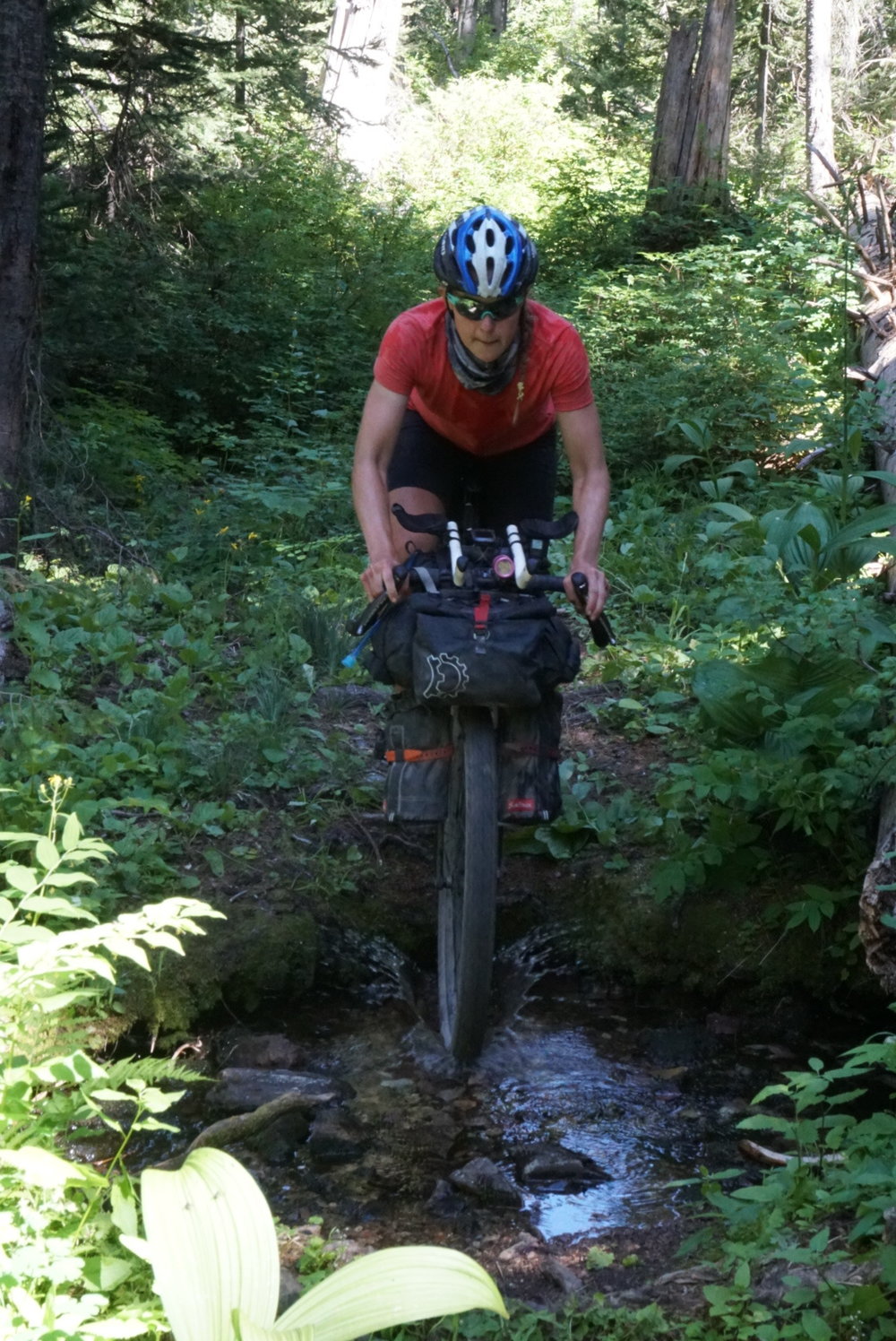 Caitlin focused while crossing a creek